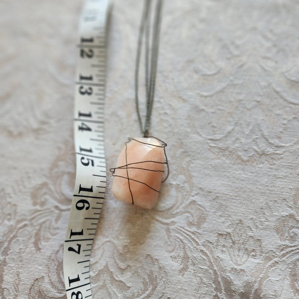 Entwinded with Silver toned wire is a Stone resemblining a Pink Salt Stone  16"